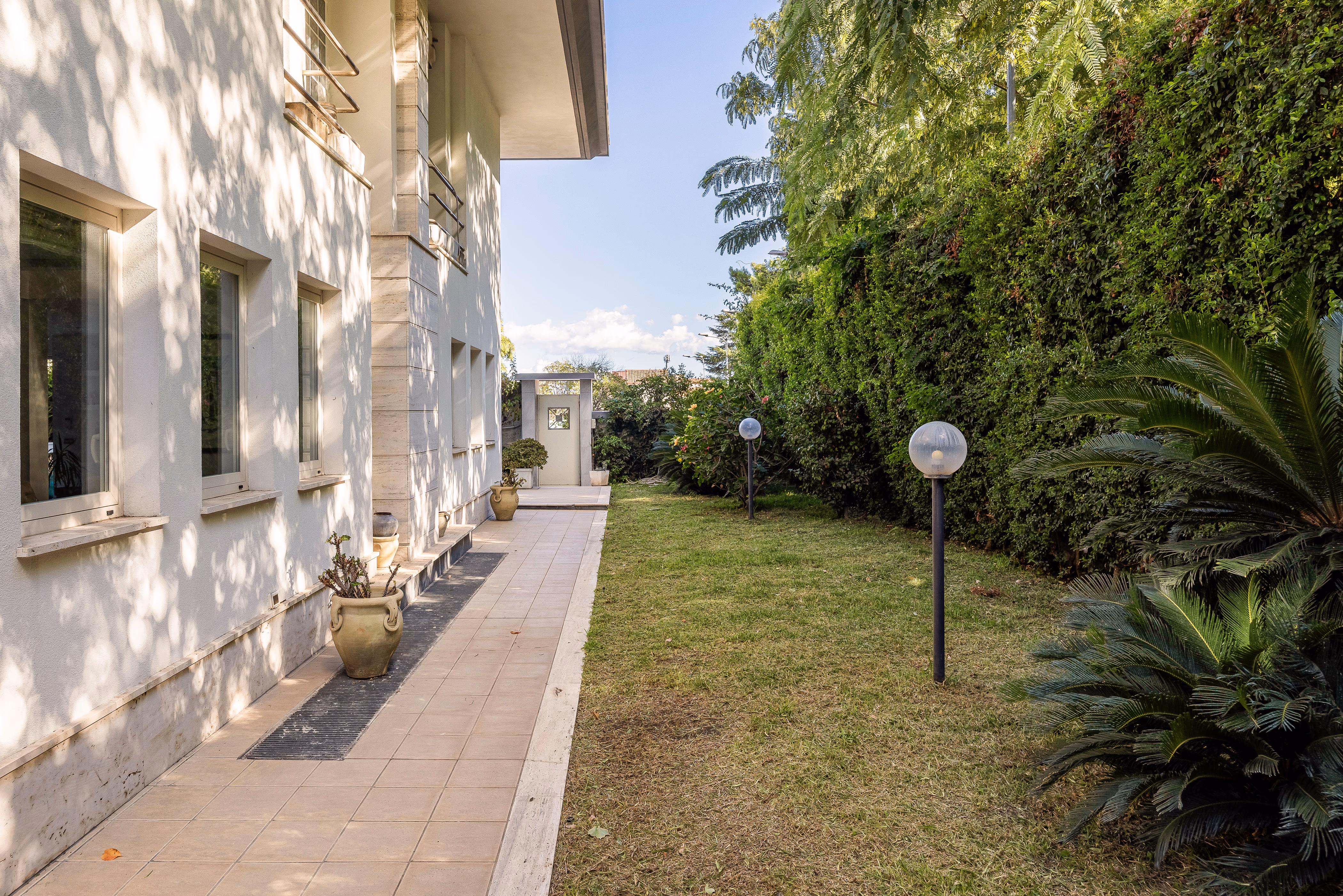Garden terrace with potted plants and stone paving