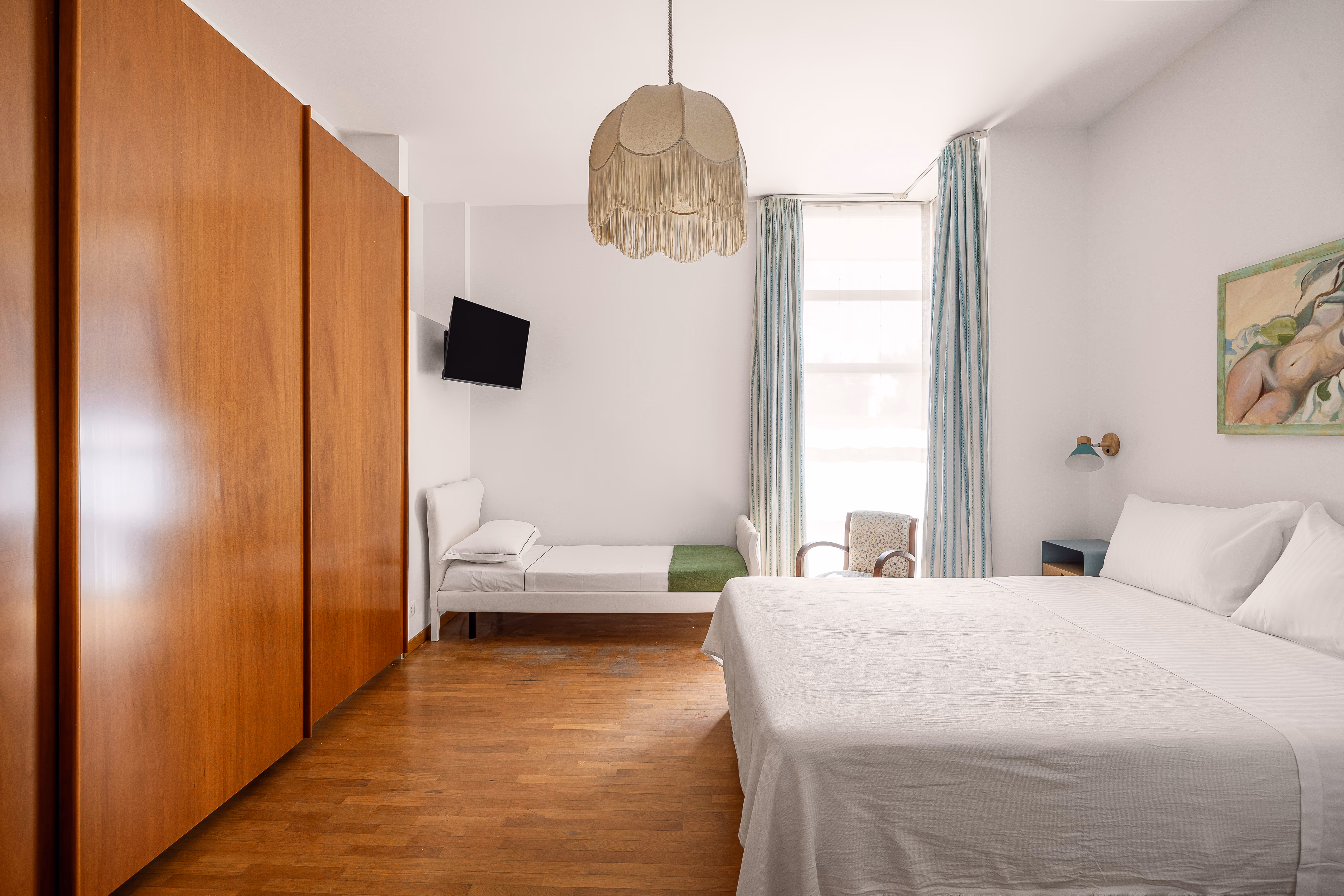 Twin bedroom with two black and gold single beds