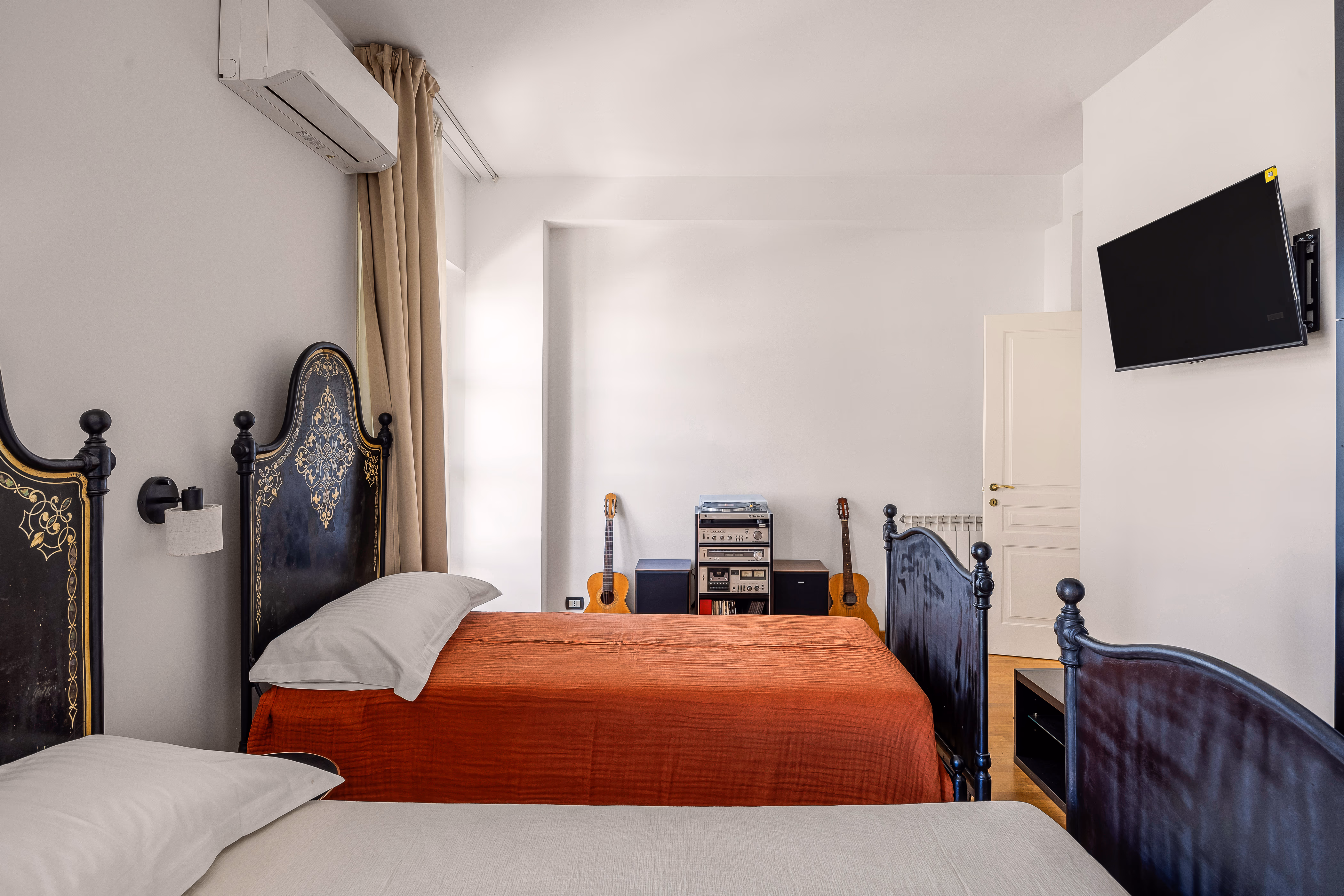 Queen bedroom with patterned floor and garden-facing window