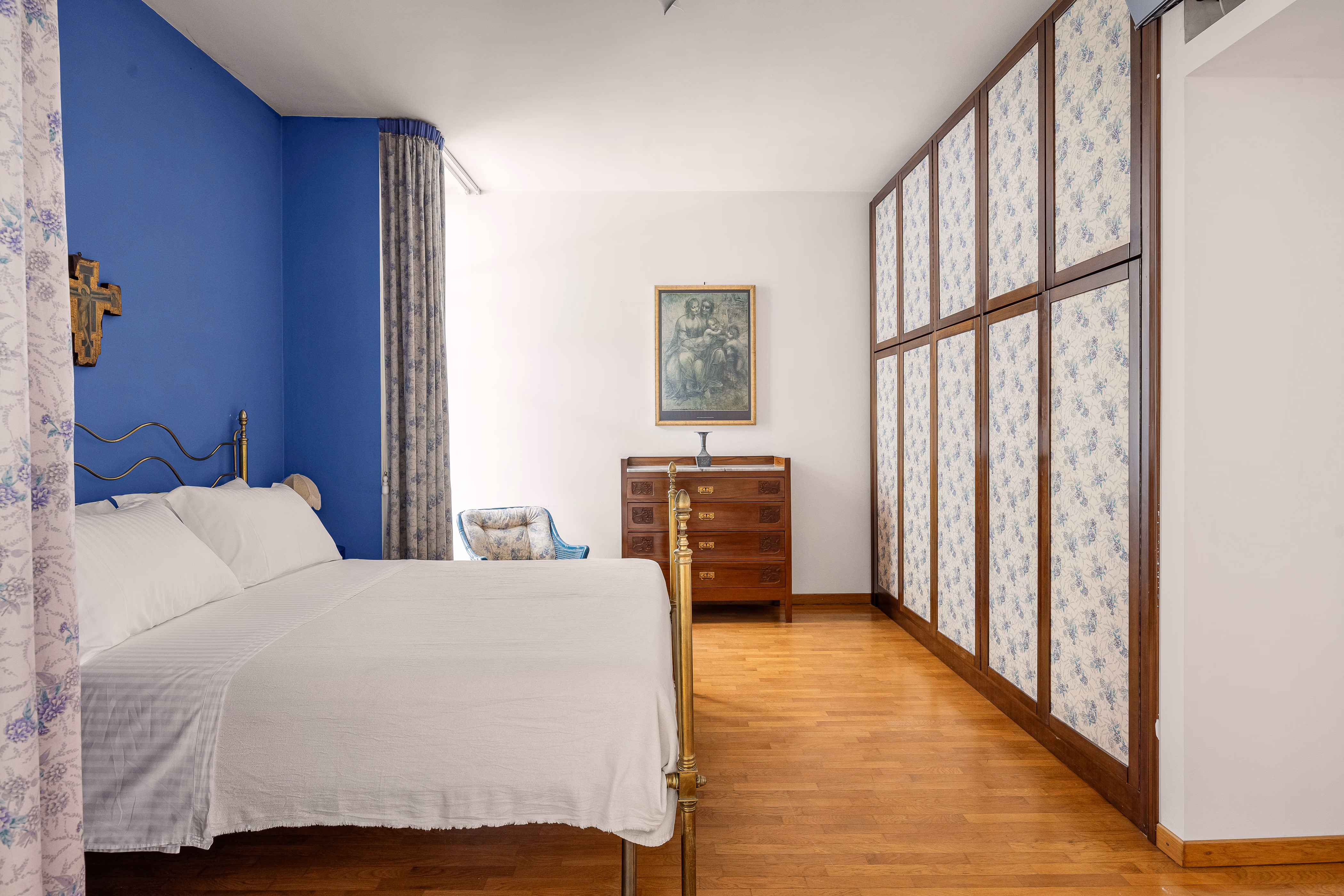 Bedroom detail with bedside lamp and framed artwork