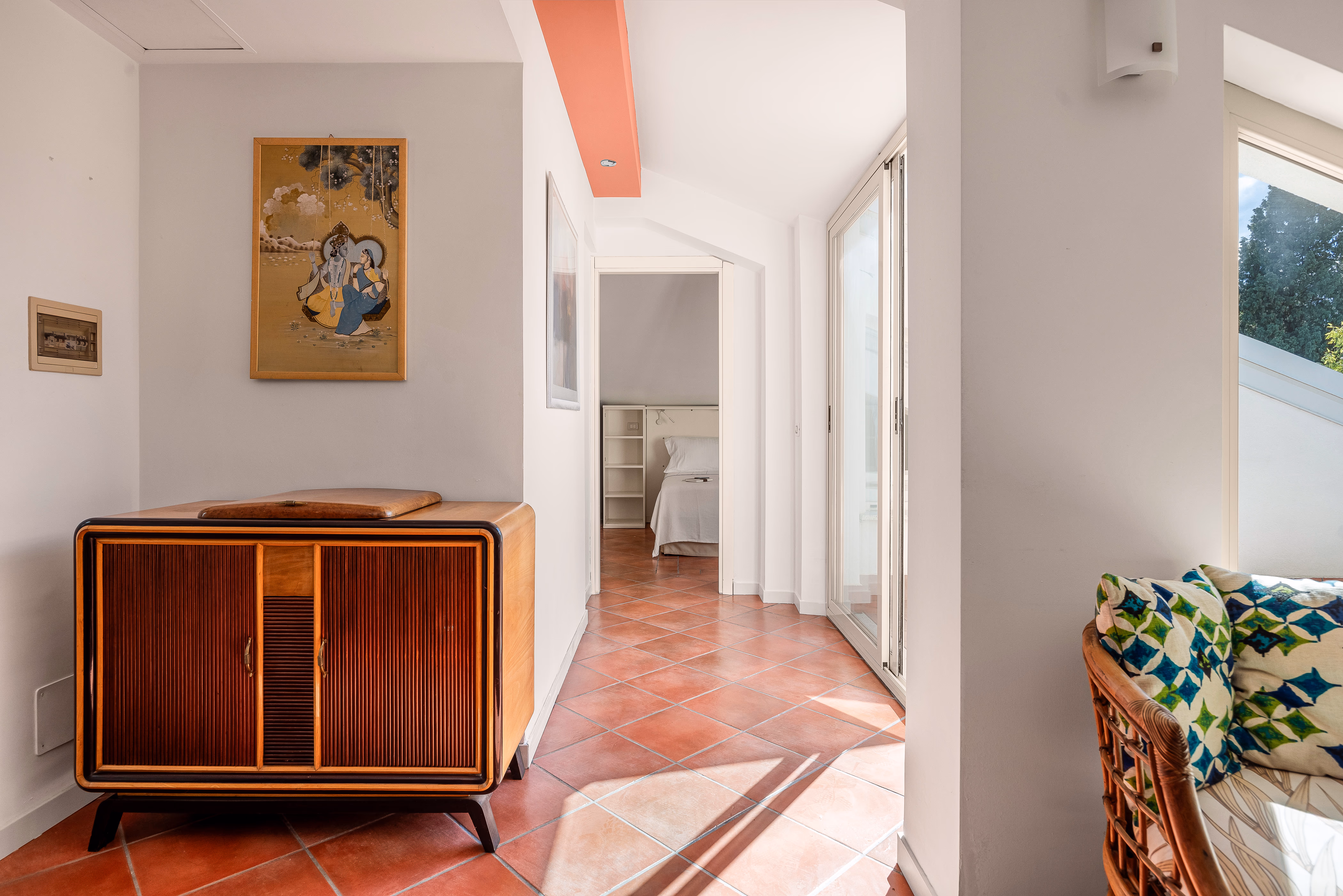 Upper apartment dining area with terracotta floor and sloped ceiling